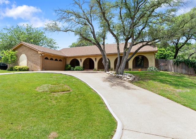 7624 Lake Highlands Dr, Fort Worth, TX 76179 - mediterranean / spanish house featuring a tile roof, a garage, concrete driveway, and stucco siding