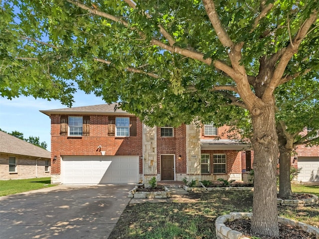 9849 Vickie Ln, Frisco, TX 75035 - view of front facade with driveway, a garage, brick siding, and stone siding