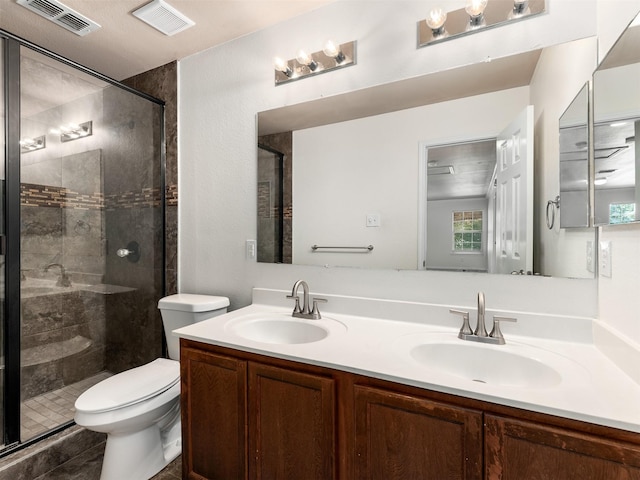 9849 Vickie Ln, Frisco, TX 75035 - bathroom featuring double vanity, toilet, a stall shower, and plenty of natural light