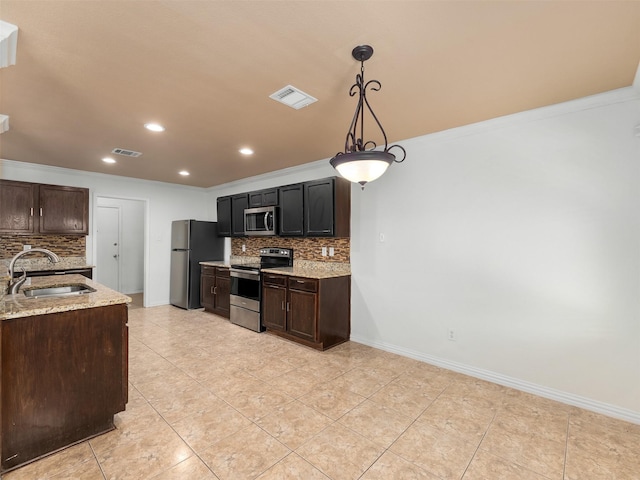 9849 Vickie Ln, Frisco, TX 75035 - kitchen with stainless steel appliances, a sink, decorative backsplash, recessed lighting, and light tile patterned floors