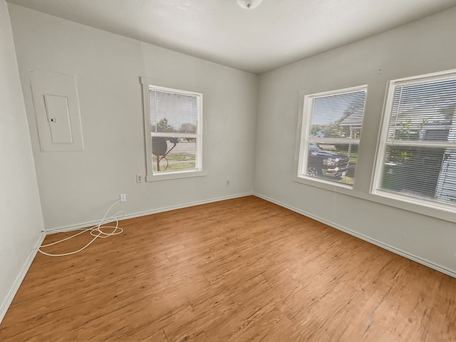 109 S 5th St, Sanger, TX 76266 - unfurnished room with electric panel, healthy amount of natural light, and wood finished floors
