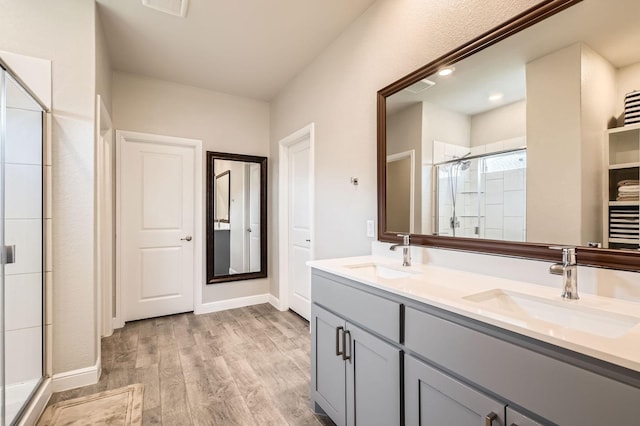 1225 Elmwood Dr, Cedar Hill, TX 75104 - full bathroom with a shower stall, wood finished floors, double vanity, and baseboards