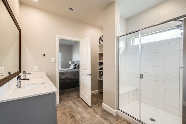 1225 Elmwood Dr, Cedar Hill, TX 75104 - full bathroom featuring wood finished floors, ensuite bathroom, double vanity, a shower stall, and baseboards