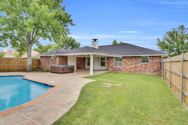 307 Pebble Creek Ln, Red Oak, TX 75154 - rear view of house featuring a hot tub, a patio, brick siding, a chimney, and a shingled roof