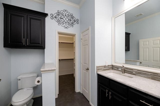 5141 Pinellas Ave, Fort Worth, TX 76244 - bathroom featuring ornamental molding, vanity, toilet, a spacious closet, and tile patterned flooring