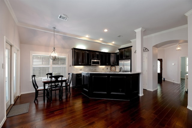 5141 Pinellas Ave, Fort Worth, TX 76244 - kitchen featuring stainless steel appliances, crown molding, arched walkways, backsplash, and baseboards