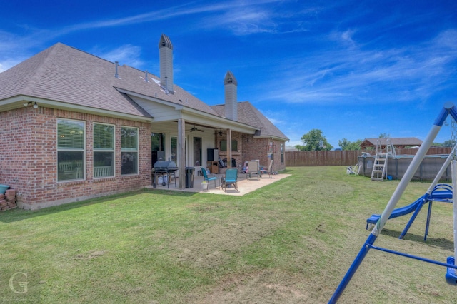 1029 Spanish Moss Cir, Bossier City, LA 71111 - rear view of property featuring a playground, brick siding, a patio area, a ceiling fan, and roof with shingles