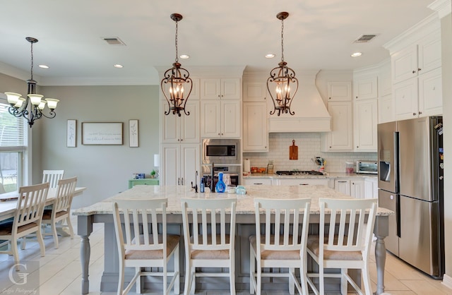 1029 Spanish Moss Cir, Bossier City, LA 71111 - kitchen featuring appliances with stainless steel finishes, a chandelier, tasteful backsplash, light stone counters, and crown molding