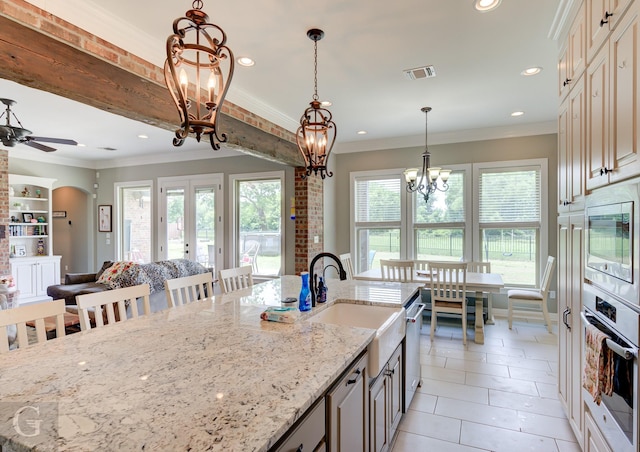 1029 Spanish Moss Cir, Bossier City, LA 71111 - kitchen with stainless steel appliances, a chandelier, a sink, ornamental molding, and light tile patterned floors