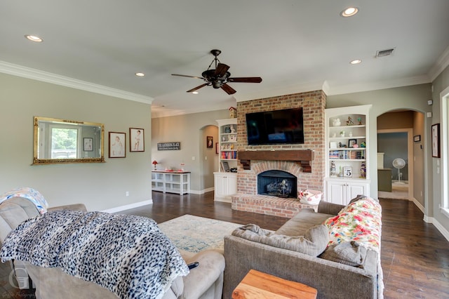 1029 Spanish Moss Cir, Bossier City, LA 71111 - living area with arched walkways, a ceiling fan, crown molding, recessed lighting, and dark wood-style floors