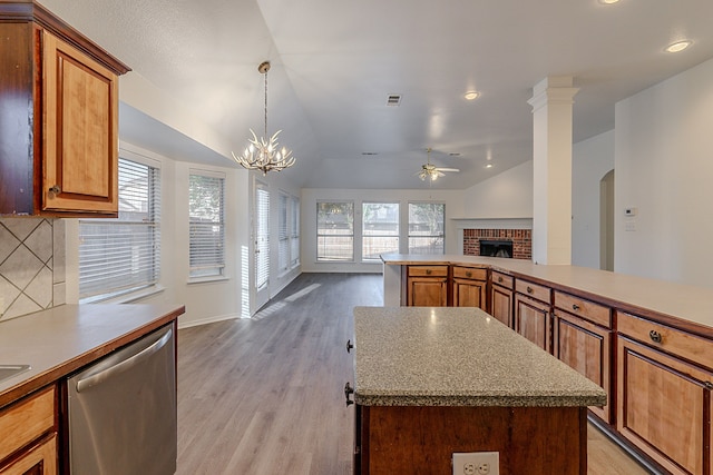7028 Herman Jared Dr, North Richland Hills, TX 76182 - kitchen with stainless steel dishwasher, a ceiling fan, a brick fireplace, open floor plan, and vaulted ceiling