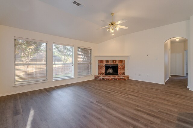 7028 Herman Jared Dr, North Richland Hills, TX 76182 - unfurnished living room with arched walkways, dark wood finished floors, vaulted ceiling, ceiling fan, and baseboards