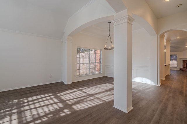 7028 Herman Jared Dr, North Richland Hills, TX 76182 - unfurnished room featuring arched walkways, dark wood-style flooring, a chandelier, crown molding, and ornate columns