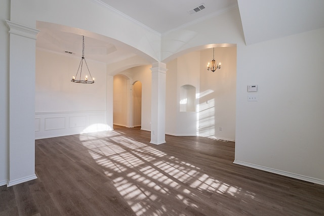 7028 Herman Jared Dr, North Richland Hills, TX 76182 - unfurnished room featuring a chandelier, crown molding, dark wood-style floors, arched walkways, and baseboards