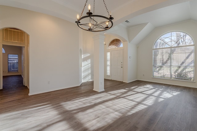 7028 Herman Jared Dr, North Richland Hills, TX 76182 - foyer entrance featuring a chandelier, wood finished floors, baseboards, arched walkways, and ornamental molding