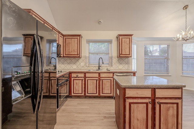 7028 Herman Jared Dr, North Richland Hills, TX 76182 - kitchen featuring black appliances, a sink, light wood-style floors, decorative backsplash, and lofted ceiling