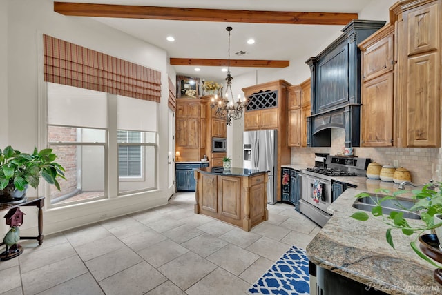129 Carondelet Ct, Bossier City, LA 71111 - kitchen with stainless steel appliances, decorative backsplash, beam ceiling, dark stone counters, and a center island