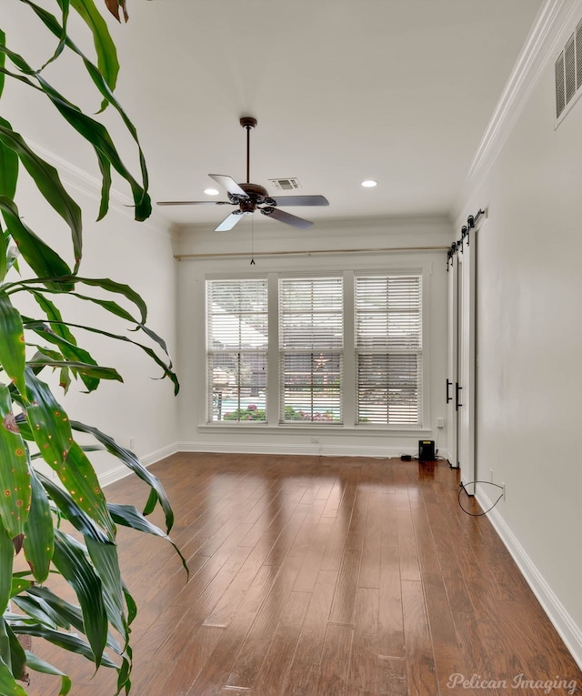129 Carondelet Ct, Bossier City, LA 71111 - unfurnished room featuring a barn door, a ceiling fan, ornamental molding, baseboards, and dark wood-style floors