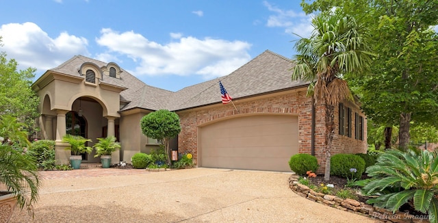 129 Carondelet Ct, Bossier City, LA 71111 - french country inspired facade with concrete driveway, brick siding, an attached garage, and roof with shingles
