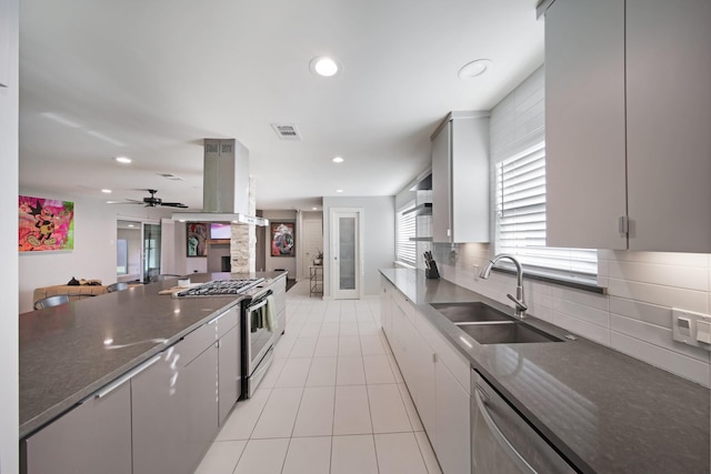 3116 Sharpview Ln, Dallas, TX 75228 - kitchen featuring gas stove, island range hood, backsplash, stainless steel dishwasher, and a ceiling fan