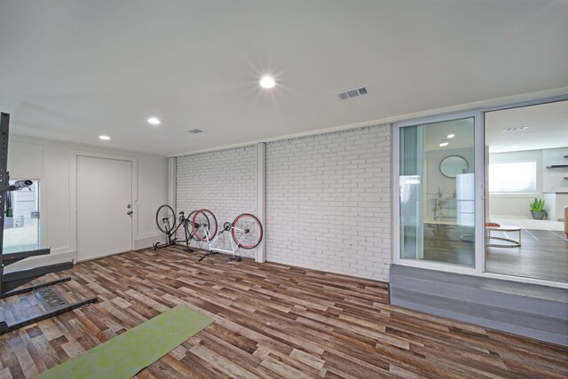 3116 Sharpview Ln, Dallas, TX 75228 - workout area featuring wood finished floors, brick wall, and recessed lighting