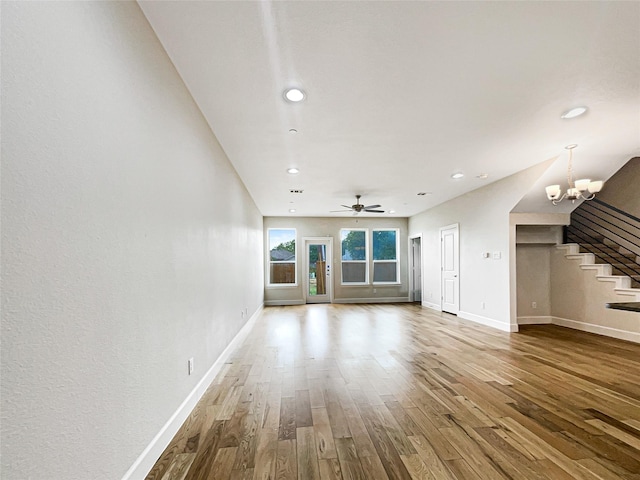5704 Woodlands Dr, The Colony, TX 75056 - unfurnished living room featuring stairway, baseboards, wood finished floors, recessed lighting, and a chandelier