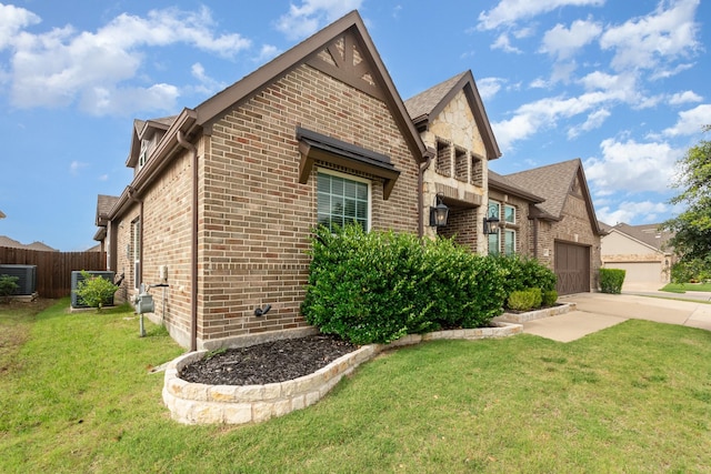 302 Micco Ln, Rockwall, TX 75087 - view of home's exterior featuring brick siding, a garage, central AC, and driveway