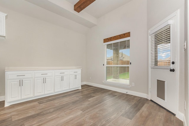 302 Micco Ln, Rockwall, TX 75087 - empty room with light wood-style flooring, beamed ceiling, and baseboards