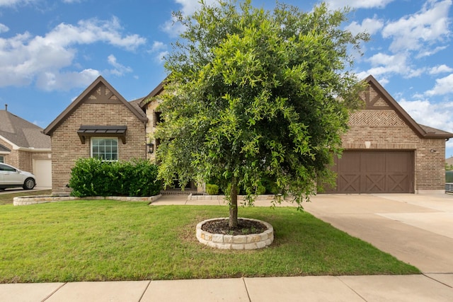 302 Micco Ln, Rockwall, TX 75087 - view of front of house with brick siding, a front lawn, and driveway
