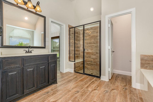 302 Micco Ln, Rockwall, TX 75087 - full bath featuring a stall shower, lofted ceiling, vanity, wood finish floors, and a bath