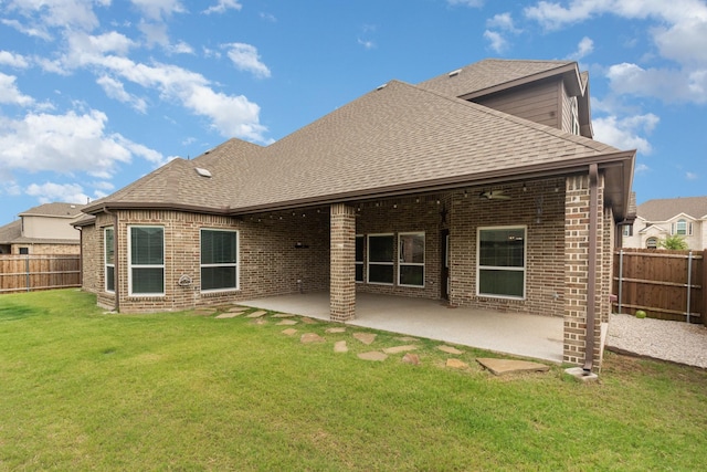 302 Micco Ln, Rockwall, TX 75087 - back of property featuring roof with shingles, brick siding, and a patio