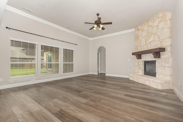 302 Micco Ln, Rockwall, TX 75087 - unfurnished living room with arched walkways, ornamental molding, ceiling fan, wood finished floors, and a stone fireplace