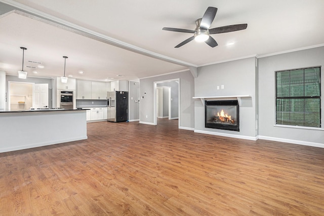 6412 Regal Rd, Forest Hill, TX 76119 - unfurnished living room featuring ornamental molding, a glass covered fireplace, light wood-style floors, recessed lighting, and a ceiling fan
