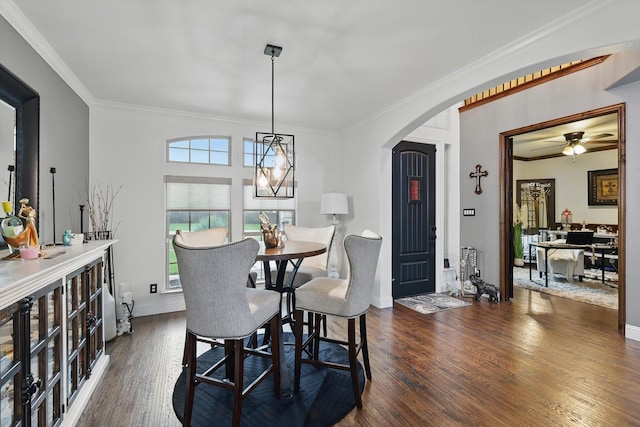 1330 Billingsley Dr, Waxahachie, TX 75167 - dining area with arched walkways, crown molding, wood finished floors, a ceiling fan, and baseboards