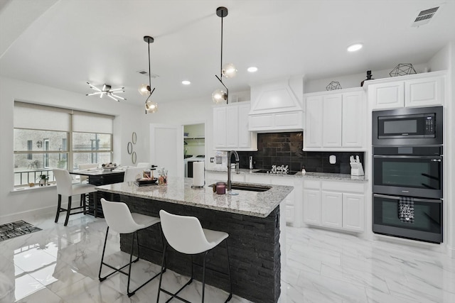 1330 Billingsley Dr, Waxahachie, TX 75167 - kitchen with black appliances, custom range hood, light marble finish flooring, a sink, and recessed lighting