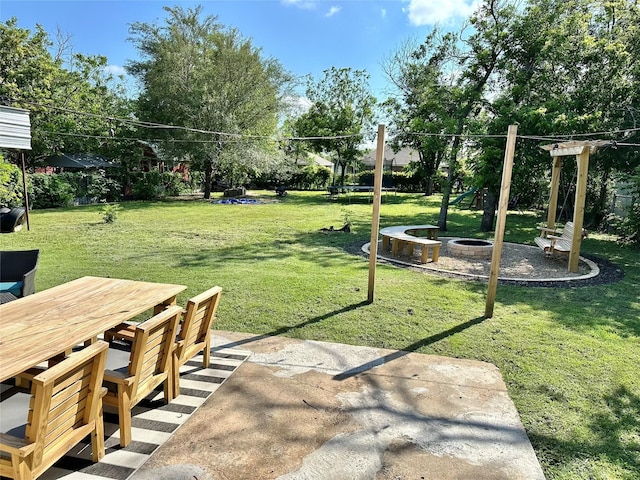 107 S Lakeview Dr, Lacy Lakeview, TX 76705 - view of grassy yard featuring a patio area, outdoor dining area, and a fire pit