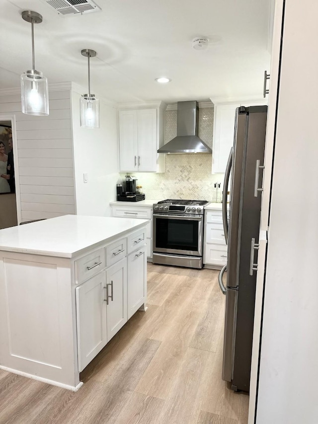 107 S Lakeview Dr, Lacy Lakeview, TX 76705 - kitchen with stainless steel appliances, wall chimney exhaust hood, light wood-style floors, white cabinetry, and a center island