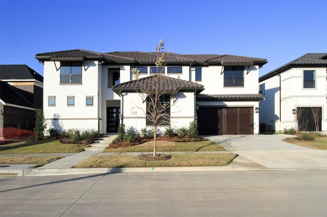 10787 Leake Ln, Frisco, TX 75035 - view of front facade featuring a tile roof, driveway, a garage, and stucco siding