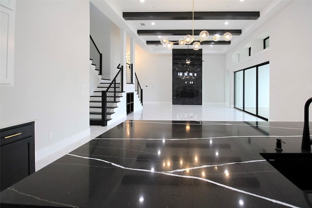 10787 Leake Ln, Frisco, TX 75035 - stairway featuring a chandelier, baseboards, and beamed ceiling