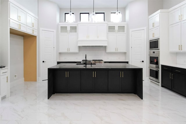 10787 Leake Ln, Frisco, TX 75035 - kitchen with light marble finish floors, white cabinets, dark cabinets, and glass insert cabinets