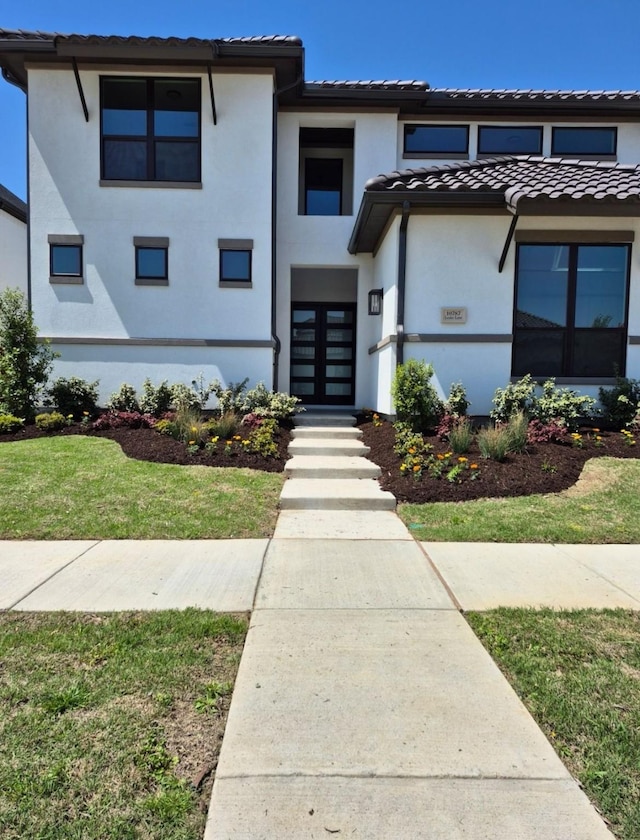 10787 Leake Ln, Frisco, TX 75035 - view of front of house featuring french doors, a tiled roof, and stucco siding