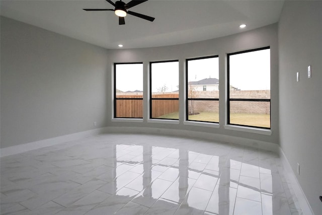 10787 Leake Ln, Frisco, TX 75035 - empty room with a ceiling fan, recessed lighting, light marble finish floors, and baseboards