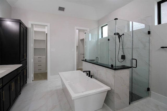 10787 Leake Ln, Frisco, TX 75035 - full bath with a marble finish shower, marble look tile flooring, a freestanding bath, and vanity
