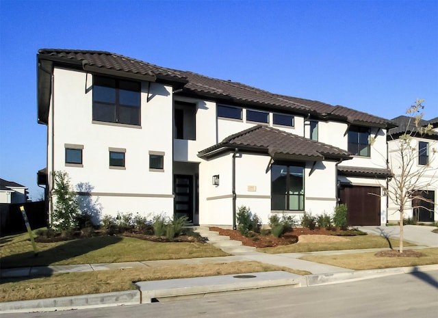 10787 Leake Ln, Frisco, TX 75035 - view of front of property with a tiled roof, concrete driveway, and stucco siding