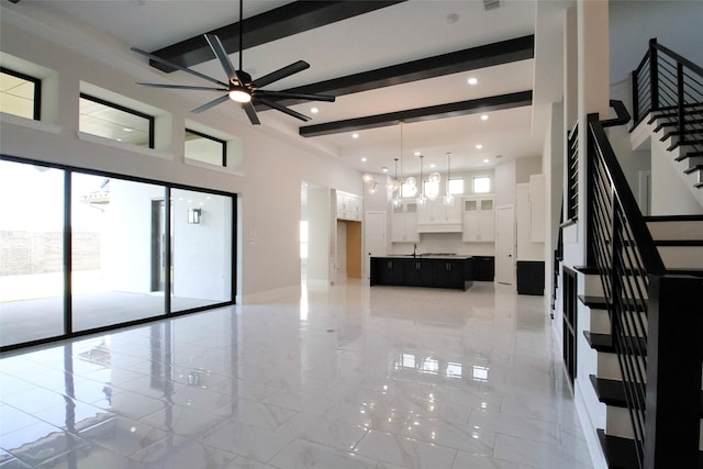 10787 Leake Ln, Frisco, TX 75035 - unfurnished living room featuring beam ceiling, stairs, ceiling fan, a towering ceiling, and recessed lighting