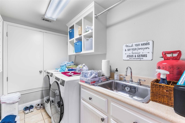 1906 S 11th St, Waco, TX 76706 - laundry room with washing machine and clothes dryer, a sink, and light tile patterned floors