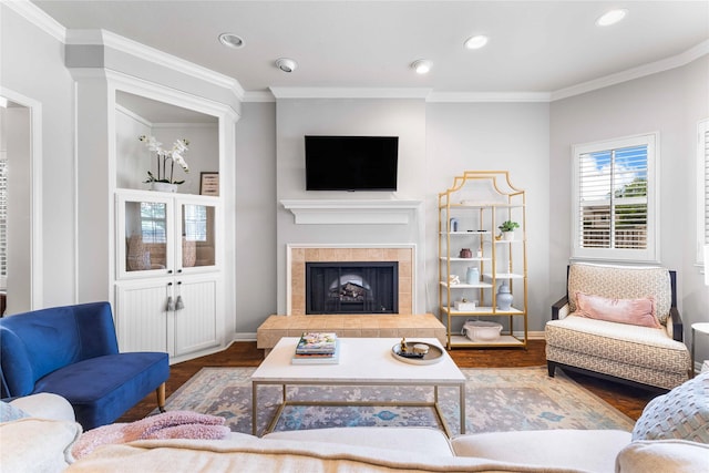 1906 S 11th St, Waco, TX 76706 - living room featuring wood finished floors, baseboards, recessed lighting, a tiled fireplace, and crown molding