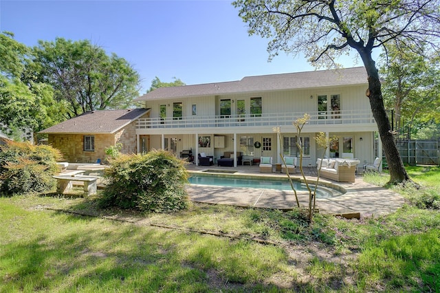 7208 Maranatha Ct, Colleyville, TX 76034 - rear view of property with an outdoor hangout area, a balcony, a patio, and an outdoor pool