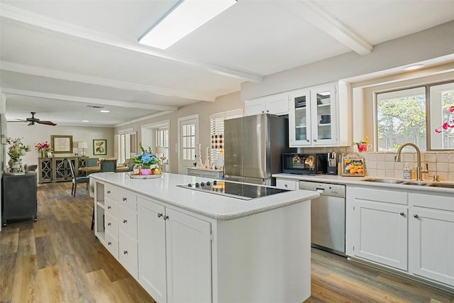 7208 Maranatha Ct, Colleyville, TX 76034 - kitchen with appliances with stainless steel finishes, beamed ceiling, a sink, a kitchen island, and tasteful backsplash