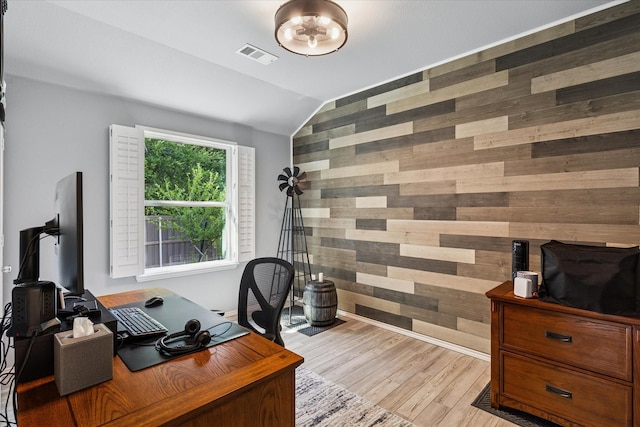 901 Freesia Dr, Little Elm, TX 75068 - office space featuring wooden walls, an accent wall, vaulted ceiling, and light wood finished floors